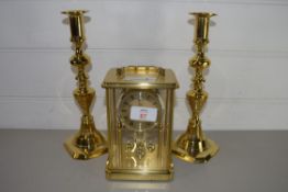 PAIR OF BRASS CANDLESTICKS AND BRASS MANTEL CLOCK