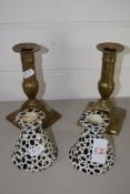 TWO POTTERY CANDLESTICKS AND TWO BRASS CANDLESTICKS