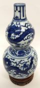 Chinese porcelain double gourd vase decorated in typical fashion with an Imperial dragon chasing the