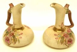 Pair of Continental ewers modelled in Royal Worcester style with the blush ground with floral