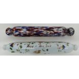 Two glass rolling pins, one with floral design with indistinct inscription, further pin with a