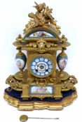 French gilt brass clock with Sevres style inlay, porcelain panels, the clock flanked by two vases