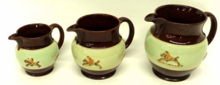 Graduated group of three Bourne Denby pottery jugs, all decorated with a sprigged hunting design (