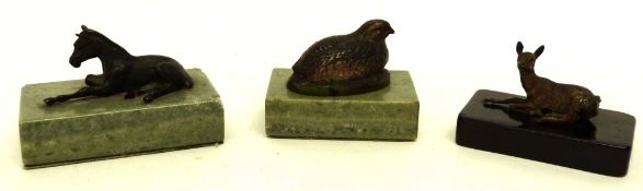 Three small paperweights, the rectangular onyx bases modelled with metal models of a horse, pheasant