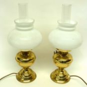 Brass oil lamps converted for electricity, plus two white shades