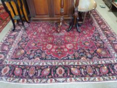 Large red ground Persian Mashad Carpet, mutlicoloured with traditional design 388cm x 270cm approx