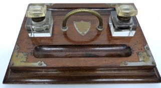 Early 20th century oak desk set with brass mounts to corners and two glass inkwells with pen