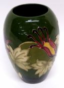 Moorcroft vase with tube lined orchid type design on green ground, 18cm high