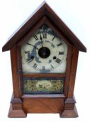 Clock in mahogany case, decorated to front with a military scene of cannon and crossed swords