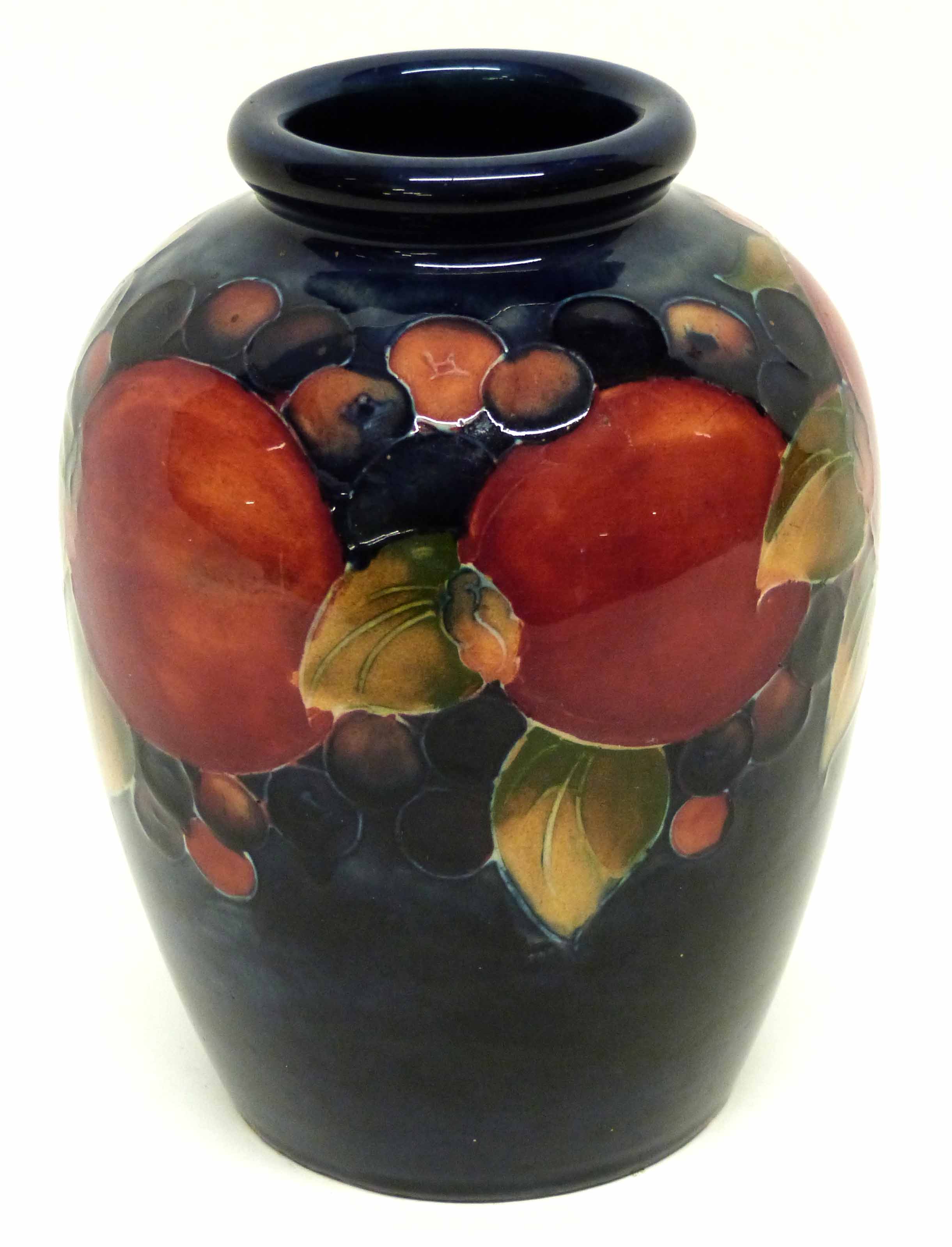 Moorcroft vase decorated in the pomegranate pattern, green WM signature to base