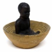 Pottery model of an African boy in basket, signed Kruger