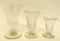 Group of 19th century glass measuring jugs with calibrated and engraved markings, probably