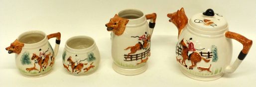 Part tea set modelled with fox hunting scenes, the spout to tea pot and milk jug and smaller jug all