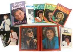A case of Barry Manilow memorabilia to include fans concert photos, books and many other items
