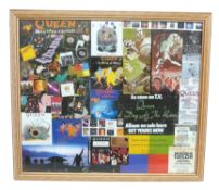 A framed collage of Queen memorabilia to include concert tickets, a party invitation, sleeve artwork