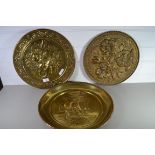 THREE BRASS TRAYS WITH VARIOUS DECORATION IN RELIEF
