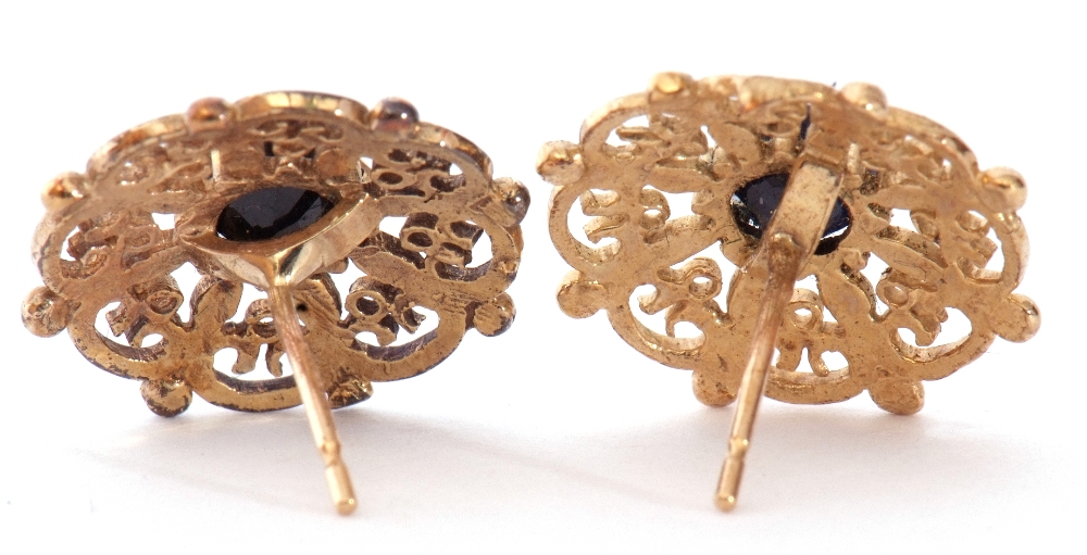 Pair of 9ct gold and sapphire earrings, the pierced shield shape design centring a round faceted - Image 2 of 2