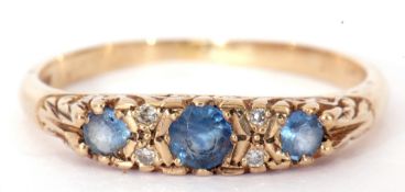 Sapphire and diamond ring featuring three round cut graduated sapphires, highlighted between with