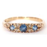 Sapphire and diamond ring featuring three round cut graduated sapphires, highlighted between with