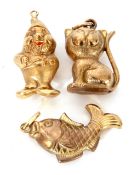 Three yellow metal charms, a gnome, fish and a cat, g/w 8gms