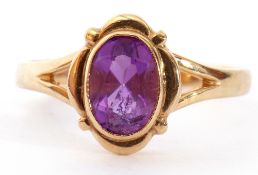 9ct gold amethyst single stone ring, the oval faceted amethyst bezel set between pierced shoulders
