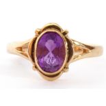 9ct gold amethyst single stone ring, the oval faceted amethyst bezel set between pierced shoulders