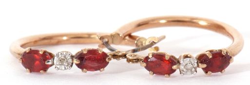 Pair of 9ct stamped hoop earrings highlighted with central diamond point between two small red