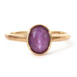 9ct gold amethyst ring, the oval faceted amethyst bezel set in a plain polished mount, size M