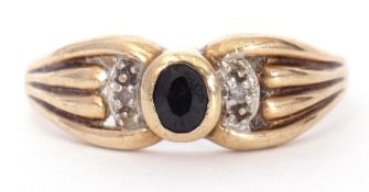 Modern 9ct gold sapphire and diamond ring, centring a bezel set oval faceted sapphire between