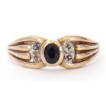 Modern 9ct gold sapphire and diamond ring, centring a bezel set oval faceted sapphire between