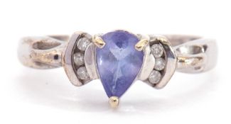 Modern 9ct white gold blue coloured stone and diamond ring, the pear shaped centre stone flanked