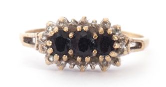 9ct gold, sapphire and diamond cluster ring centring three oval dark sapphires within a small