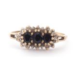 9ct gold, sapphire and diamond cluster ring centring three oval dark sapphires within a small