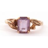 9ct gold and amethyst ring centring a step cut pale amethyst raised between textured tapering