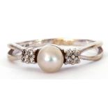 Modern 14K stamped cultured pearl and diamond ring, the cultured pearl set between small diamond