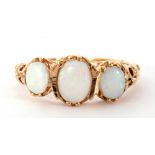 Modern 9ct gold opal ring featuring three graduated oval cabochon opals in an ornate gallery and