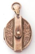 Victorian gold locket, of oval hinged design, chased and engraved with an overlapped belt detail,