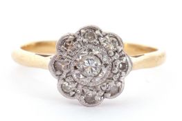 Antique diamond cluster ring, a flowerhead design centring a round brilliant cut diamond with a