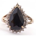 Modern haematite and diamond ring, the pear shaped centre faceted stone raised above a small diamond