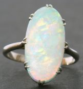 Large opalescent dress ring of oval cabochon shape, 18 x 10mm, prong claw set in a basket mount to a
