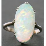 Large opalescent dress ring of oval cabochon shape, 18 x 10mm, prong claw set in a basket mount to a