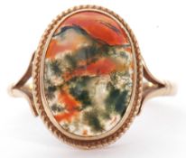 9ct gold moss agate ring, the oval cabochon centre agate 15 x 8mm, in a cut down setting with rope