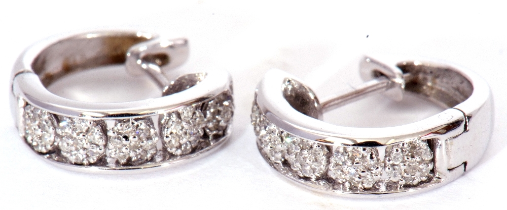 Pair of modern precious metal small diamond set hoop earrings, hinged with post fittings, stamped