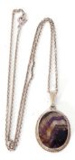 A Blue John oval pendant, 30 x 20mm, framed in a white metal mount and rope twist frame, suspended