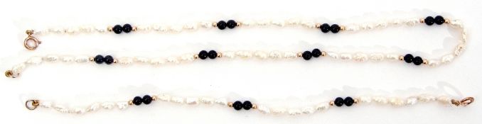 Matching necklace and bracelet of white freshwater cultured pearls interspersed by pairs of black