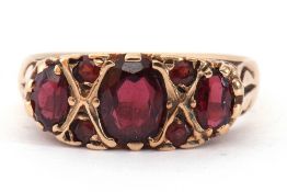 9ct gold and garnet ring featuring three oval graduated garnets highlighted with a further four