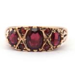 9ct gold and garnet ring featuring three oval graduated garnets highlighted with a further four