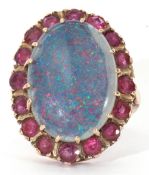 9ct gold opal doublet and ruby ring, the large cabochon opal doublet multi-claw set within a