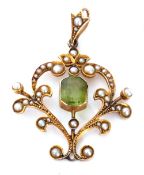 Edwardian open work pendant centring a cushion cut peridot in cut down setting, the scroll frame