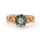 9ct gold emerald and diamond cluster ring, centring a small diamond in an illusion setting raised